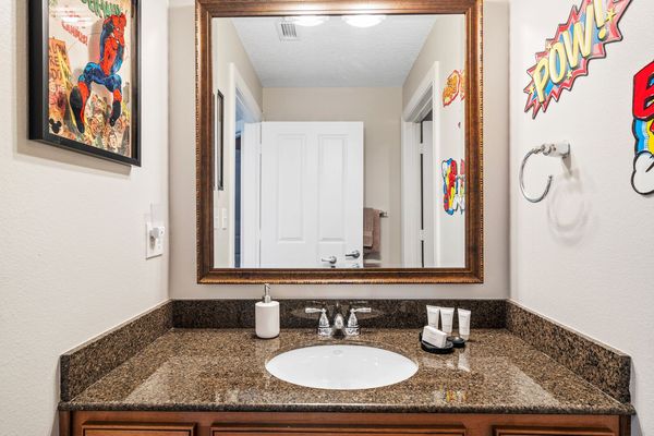 The two themed bedrooms have access to a fun superhero-inspired bathroom with combined tub/shower