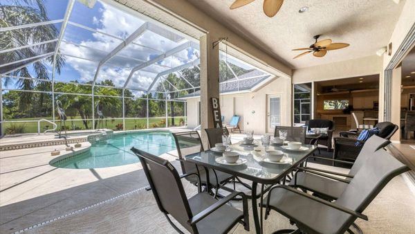 Dine overlooking the pool and golf course beyond