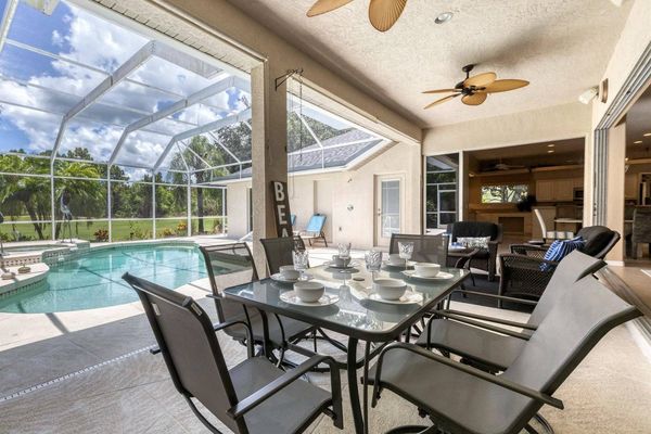 Dine overlooking the pool and golf course beyond