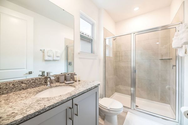 The en suite bathroom includes a walk-in shower