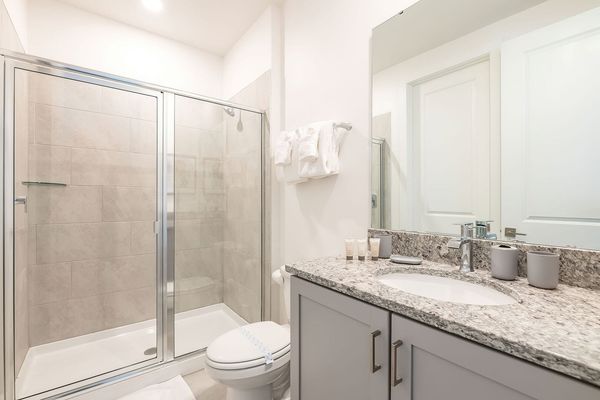 The en suite bathroom has a walk-in shower