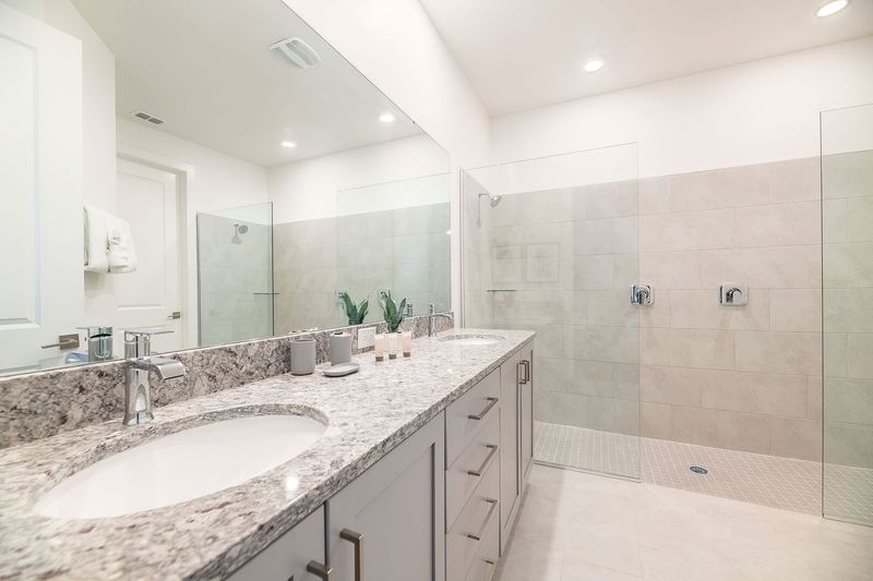 The en suite bathroom has a dual vanity and double shower