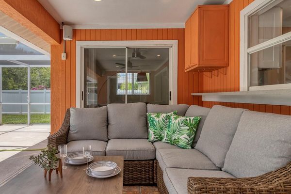 Comfortable outdoor seating space overlooking the pool and private backyard