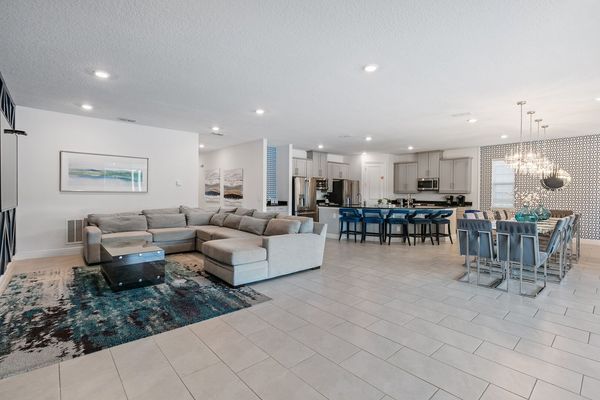 Gather in the airy open floor plan, where living, dining, and kitchen flow seamlessly.