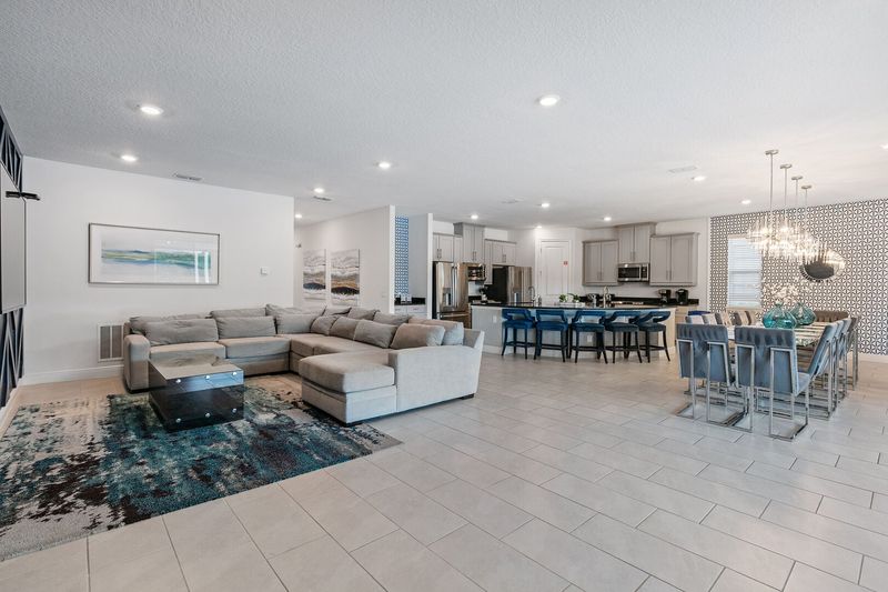 Gather in the airy open floor plan, where living, dining, and kitchen flow seamlessly.