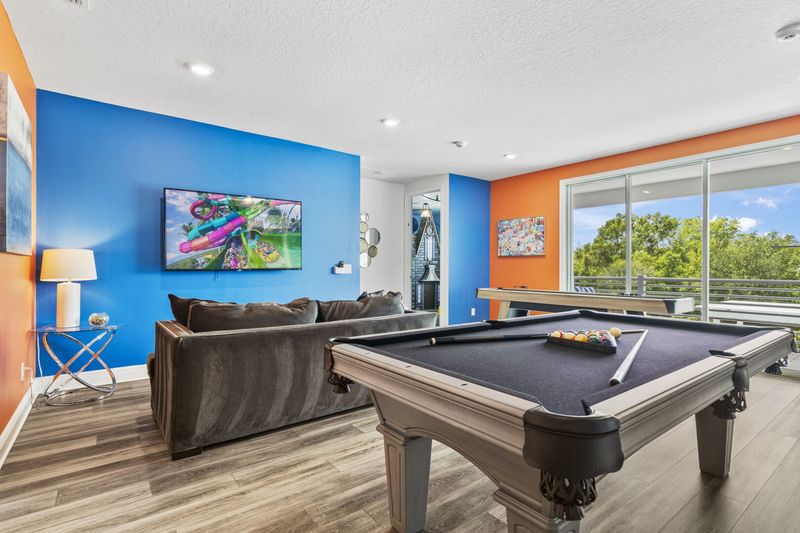Upstairs, you'll find the entertainment loft with comfortable sofa, shuffleboard, pool table.