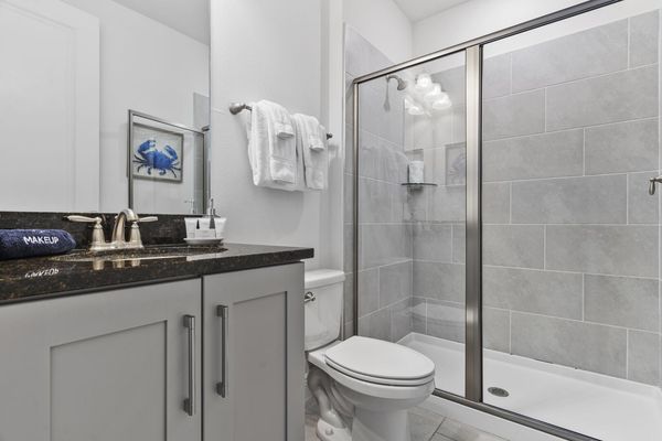 Refresh yourself in the modern shower area, featuring sleek fixtures and ample space for a rejuvenating experience