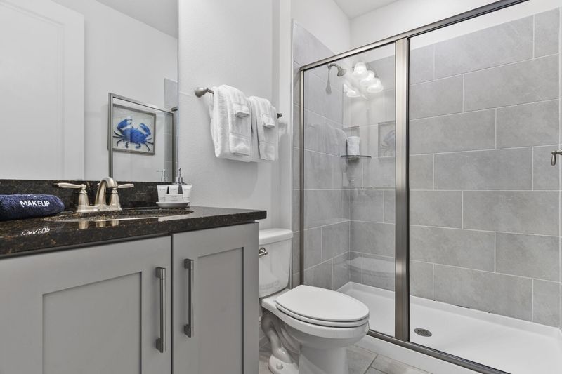 Refresh yourself in the modern shower area, featuring sleek fixtures and ample space for a rejuvenating experience