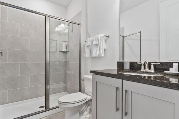 Refresh yourself in the modern shower area, featuring sleek fixtures and ample space for a rejuvenating experience