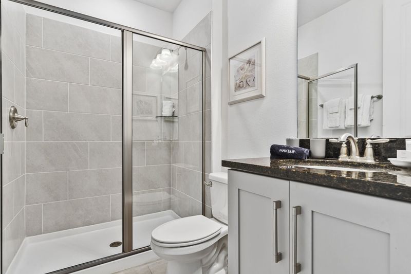 Relax in the ensuite bath, where functionality meets refined aesthetics.