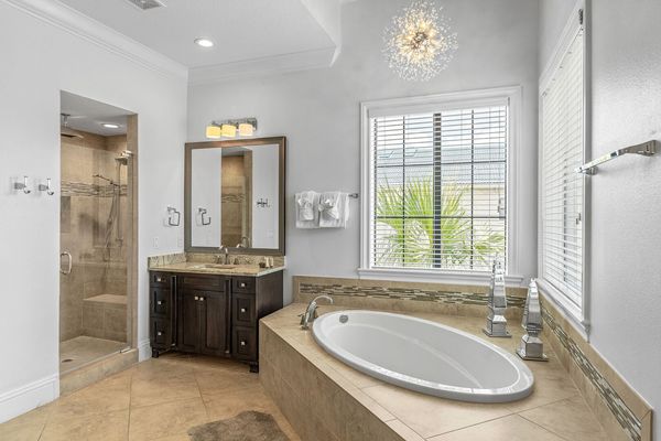 En-suite bathroom with large soaking tub and glass door walk-in shower
