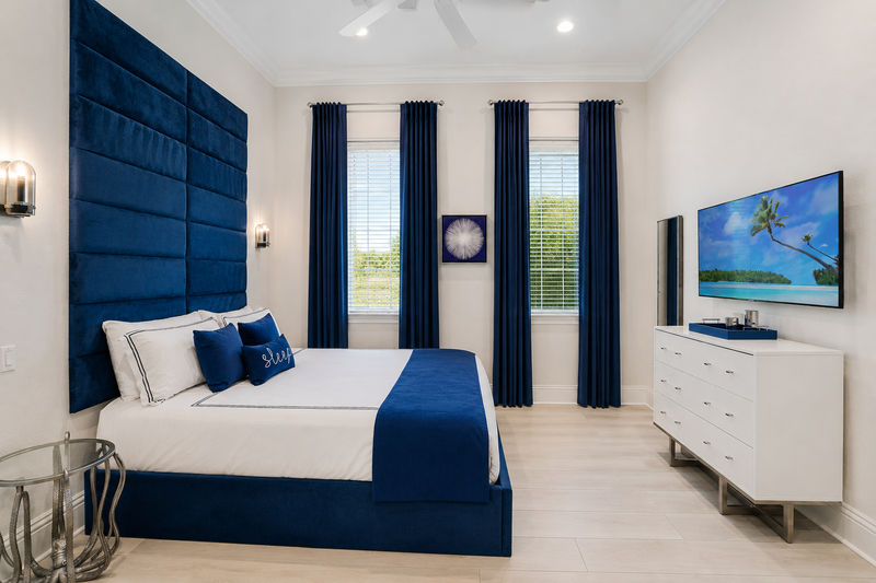 Suite # 4. A first-floor king sized bedroom with double doors and TV