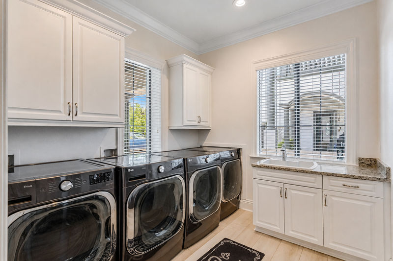 The first floor laundry room includes 2 washers and 2 dryers