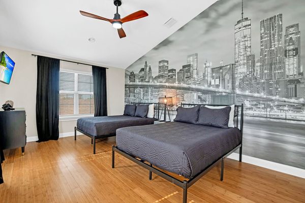 2 full sized beds attached to a half bathroom located on the 3rd floor.