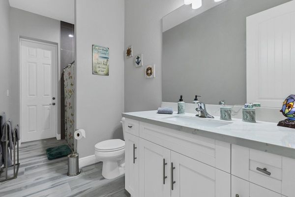 Spacious guest bathroom with lanai access and walkin (step down) shower