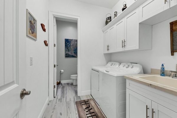 Spacious laundry room with full size washer and dryer