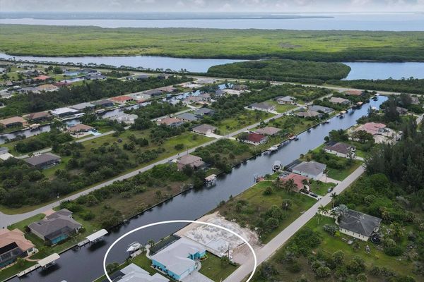 South Gulf Cove house aerial view of the canals to Charlotte harbor and the Gulf of Mexico beyond (Boat lift not available)