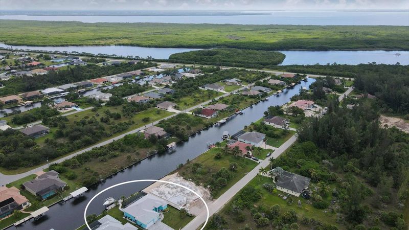 South Gulf Cove house aerial view of the canals to Charlotte harbor and the Gulf of Mexico beyond (Boat lift not available)