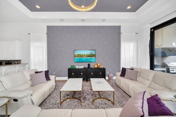 Welcome to our snug living area, where a plush sofa invites you to sink in and relax. Vibrant and inviting, it's the perfect spot to unwind and hang out with loved ones.