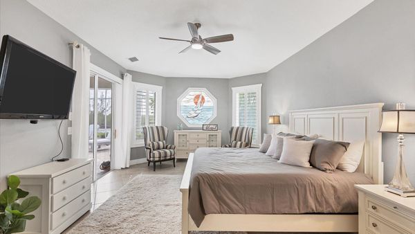 King bed in the master bedroom with lanai access and ensuite bathroom