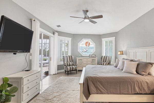 King bed in the master bedroom with lanai access and ensuite bathroom