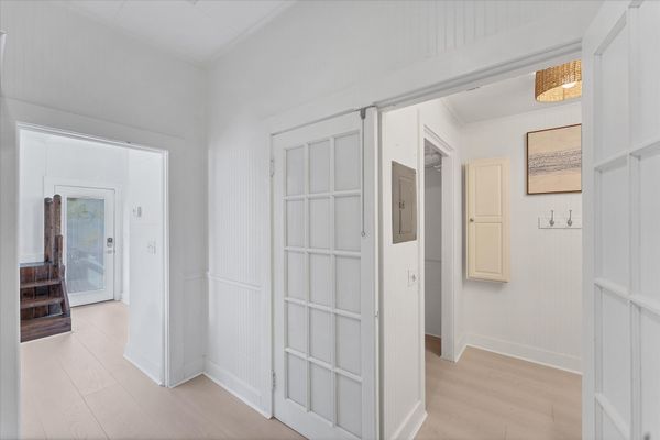 Doorway off kitchen to main full bathroom and walk-in closet
