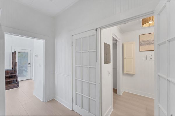 Doorway off kitchen to main full bathroom and walk-in closet