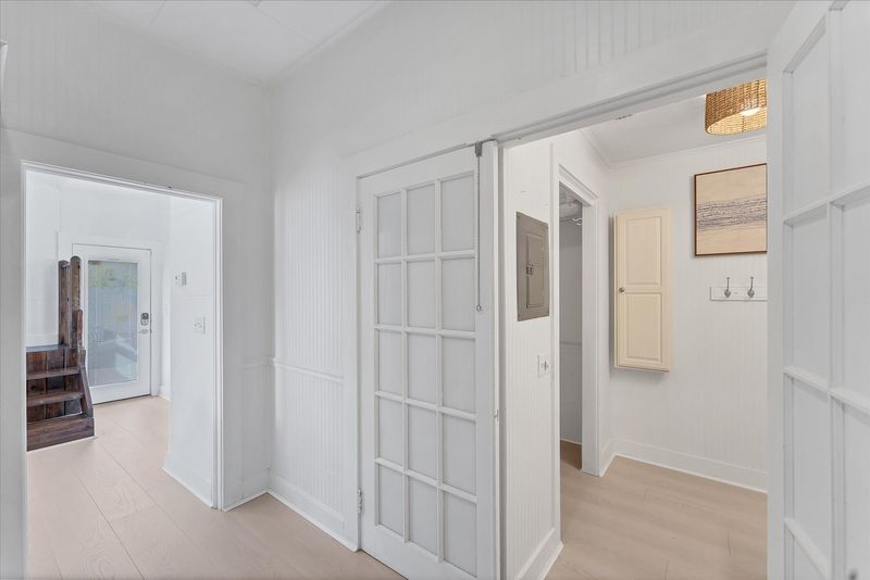 Doorway off kitchen to main full bathroom and walk-in closet
