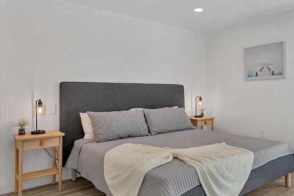 Primary bedroom with king bed, attached bathroom, access to backyard