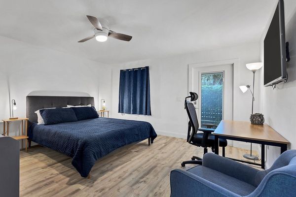 King bedroom #2. Attached bathroom. Entry door to side walkway. Desk & chair. 50-inch Smart TV