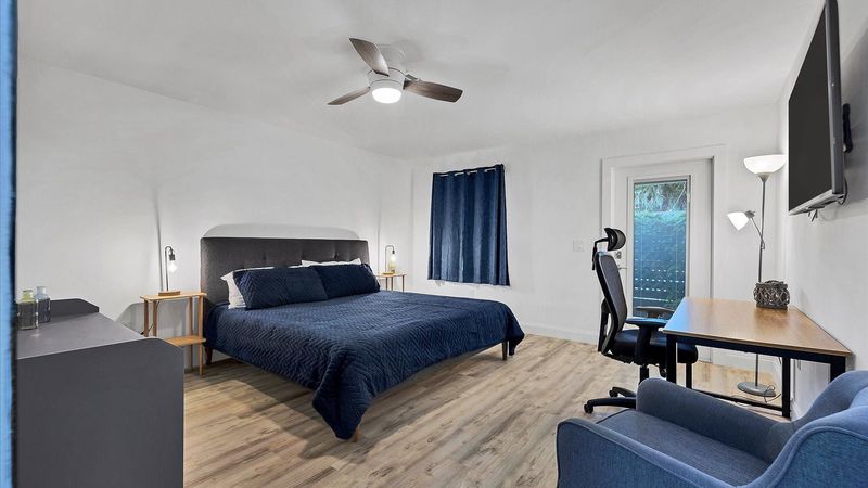 King bedroom #2. Attached bathroom. Entry door to side walkway. Desk & chair. 50-inch Smart TV