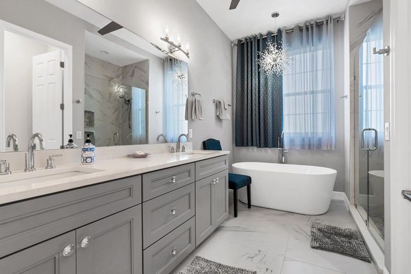 Primary attached bathroom with walk-in shower, soaking tub, and double vanities