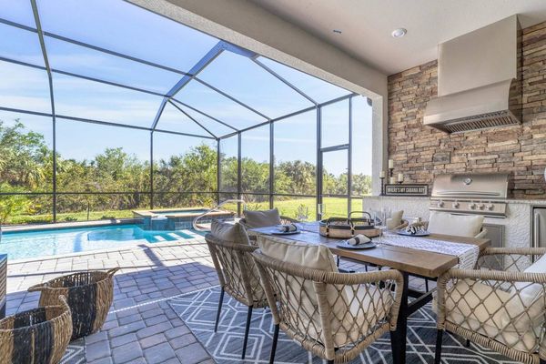 Gorgeous lanai with dining table, outdoor kitchen, pool and spa