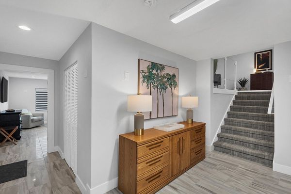 Bottom floor with another guest bedroom and a full bathroom- exit to the pool deck