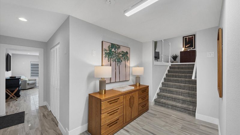 Bottom floor with another guest bedroom and a full bathroom- exit to the pool deck