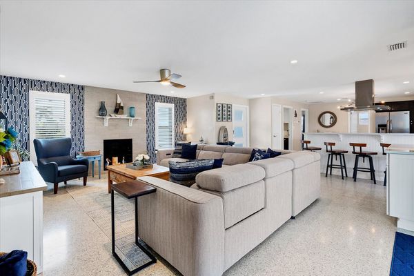 The living room overlooks the lanai and pool and canal
