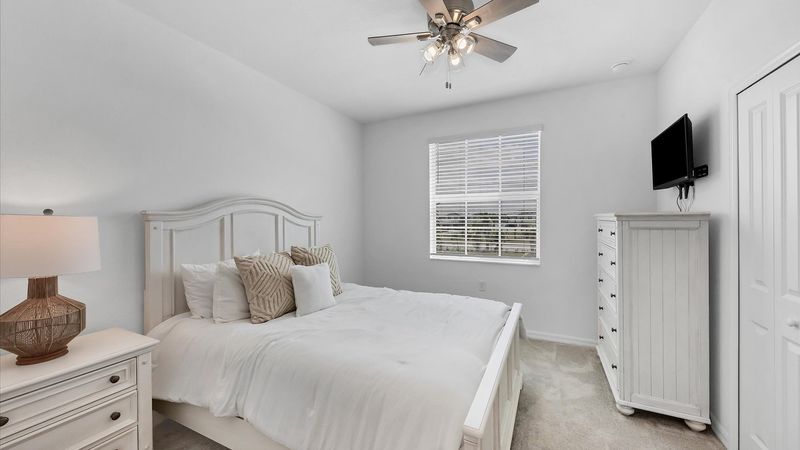 Queen bed in second bedroom with access to the guest bathroom