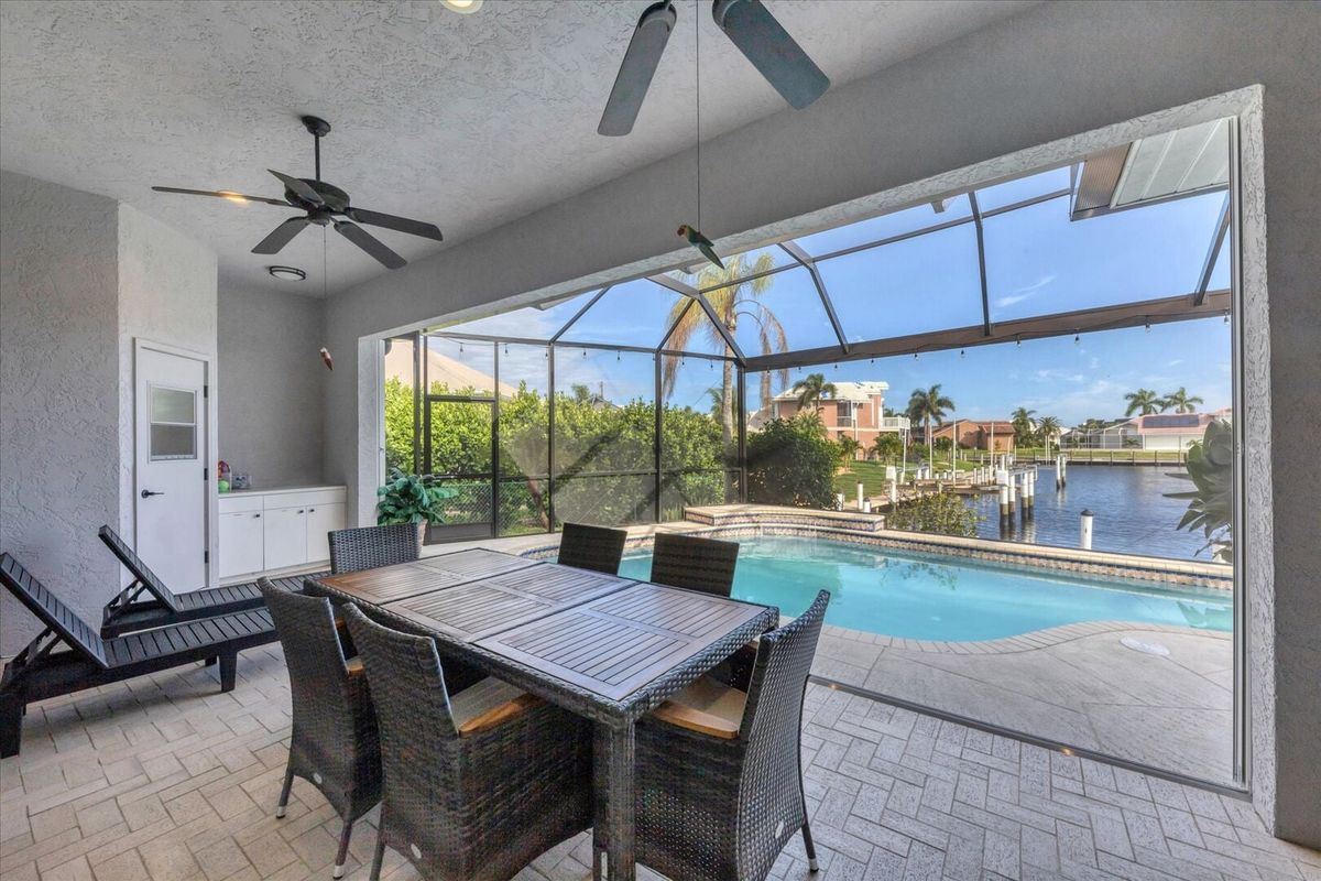 Spacious outdoor area with dining table overlooking the water (Boat lift not available)