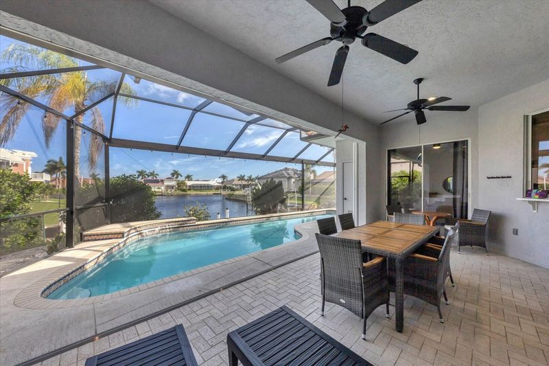 Spacious outdoor area with dining table overlooking the water