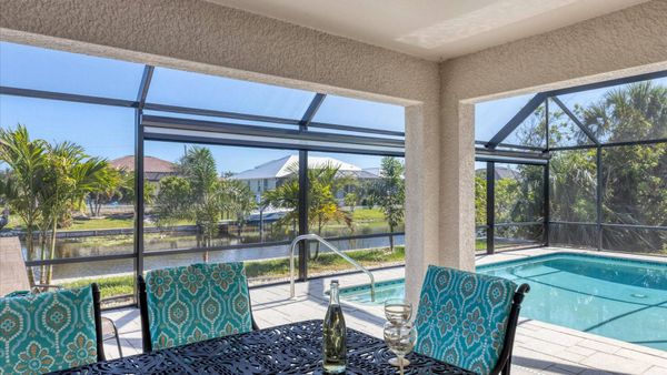 Al fresco dining area overlooking the pool and canal