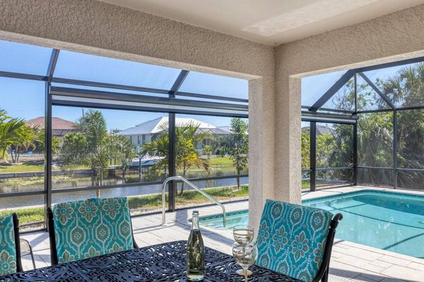 Al fresco dining area overlooking the pool and canal