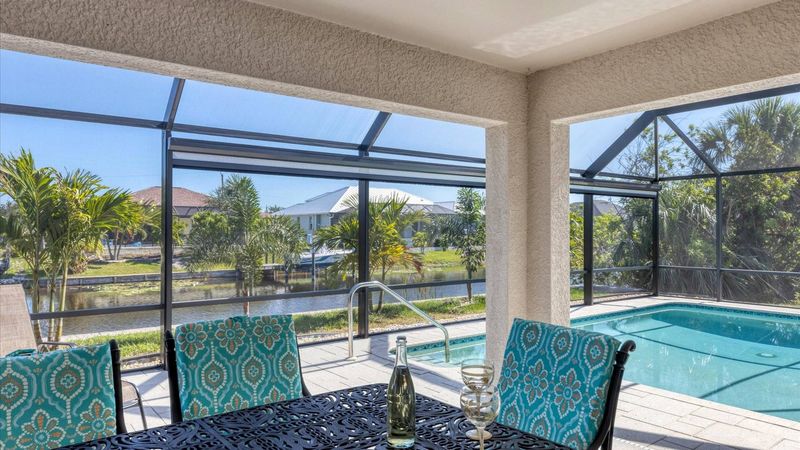 Al fresco dining area overlooking the pool and canal