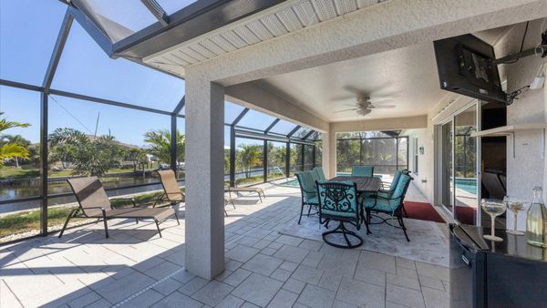 Al fresco dining area overlooking the pool and canal