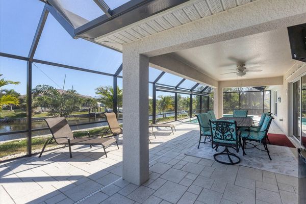 Al fresco dining area overlooking the pool and canal