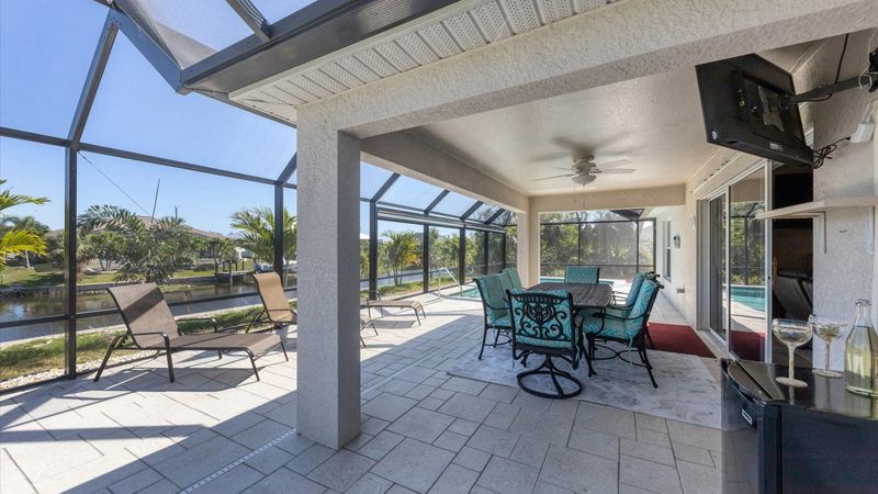 Al fresco dining area overlooking the pool and canal