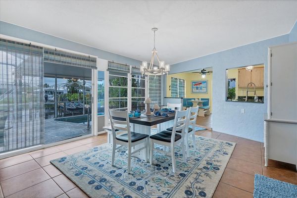 Bright and open dining room overlooks the canal and lanai