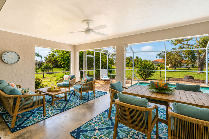 Spacious lanai with covered seating areas and pool