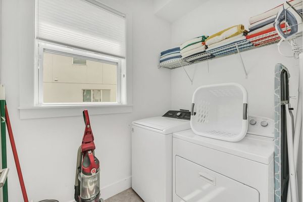 The ground floor laundry room has 2 sets of washers and dryers