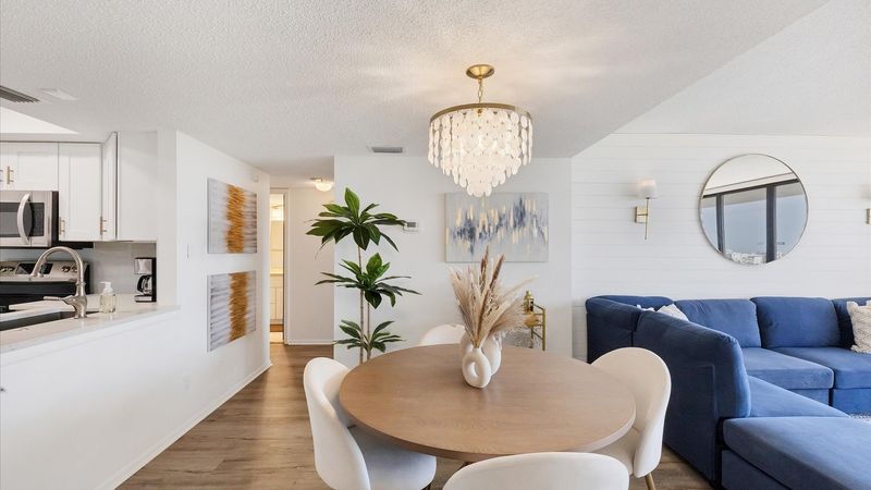 Dining area with hall leading to second bedroom