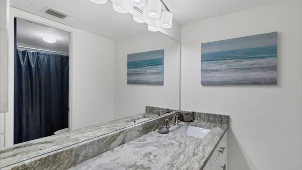 beautiful vanity in primary bathroom with shower/tub combo